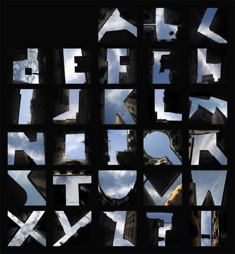 Photograph of letter shapes formed by the sky and tall buildings.